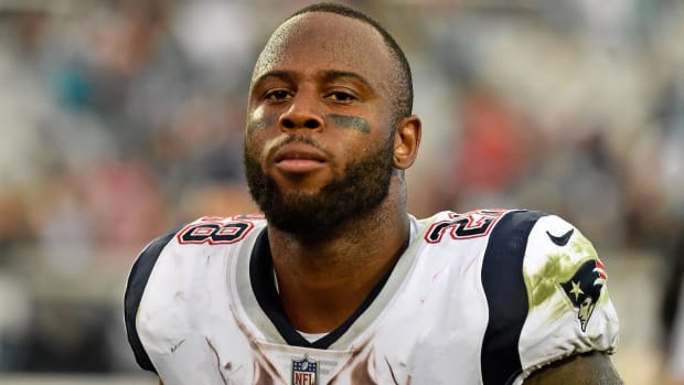 Patriots running back James White runs off the field after a game.